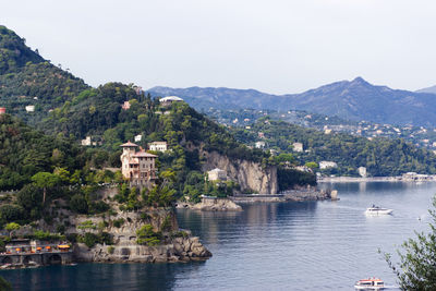 Buildings by sea against sky in the gulf of genua