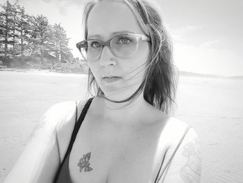 Portrait of young woman standing on beach