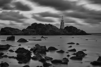 Rocks in sea against sky