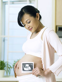 Side view of pregnant woman at home