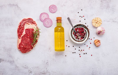 High angle view of fruits and bottle against white background