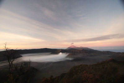 View of volcanic landscape against sky during sunrise