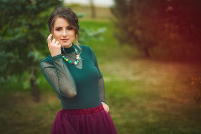 Portrait of young woman standing outdoors