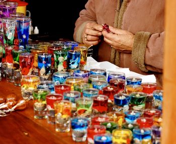 Close-up of woman selling souvenirs at store