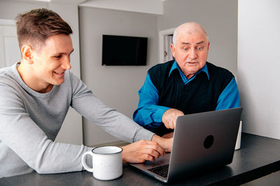 Young man using laptop while sitting at home