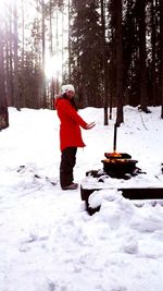 Person with umbrella on snow covered trees