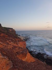 Scenic view of sea against clear sky during sunset