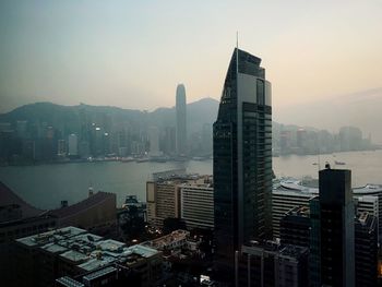 High angle view of buildings amidst sea against clear sky