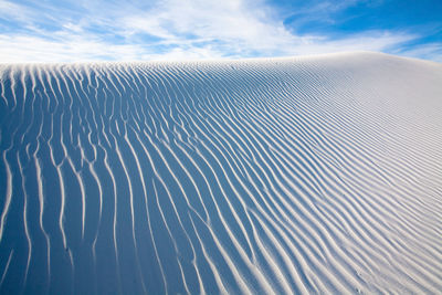 Scenic view of wave patterns on desert against sky