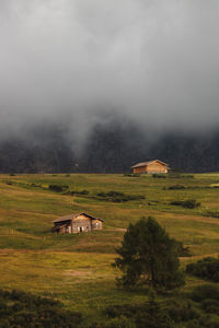 Scenic view of landscape and houses against sky