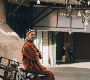 Full length of man standing by building in city