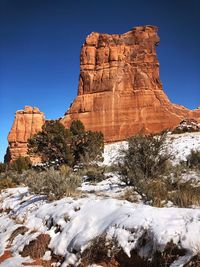 Rock formation against clear sky during winter