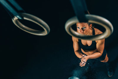 High angle view of woman standing against black background