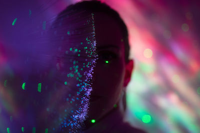 Close-up portrait of woman with illuminated lights