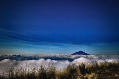 Scenic view of land against blue sky