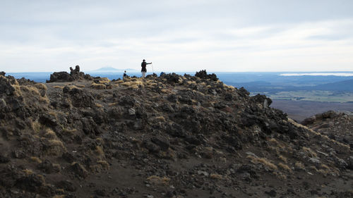 People looking at the view of mt taranaki  from tongariro alpine crossing 