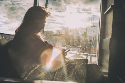 Man looking through window