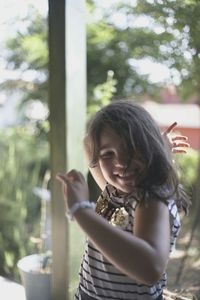 Smiling girl standing on porch