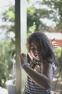 Portrait of smiling girl standing outdoors