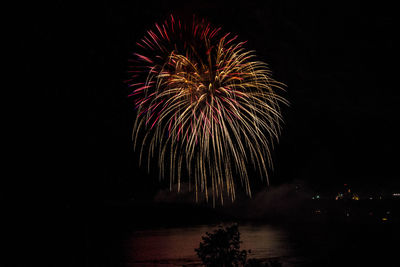 Firework exploding over mississippi river against sky