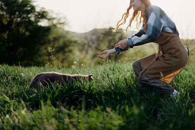 Side view of man standing on grassy field