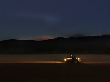 Scenic view of desert against sky at night