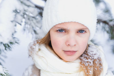 Portrait of young woman in hat during winter