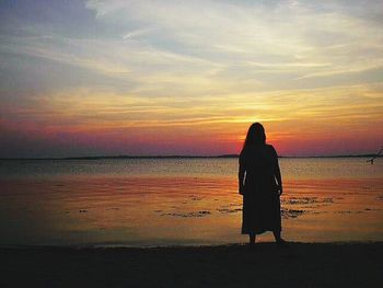 Silhouette of man standing on beach