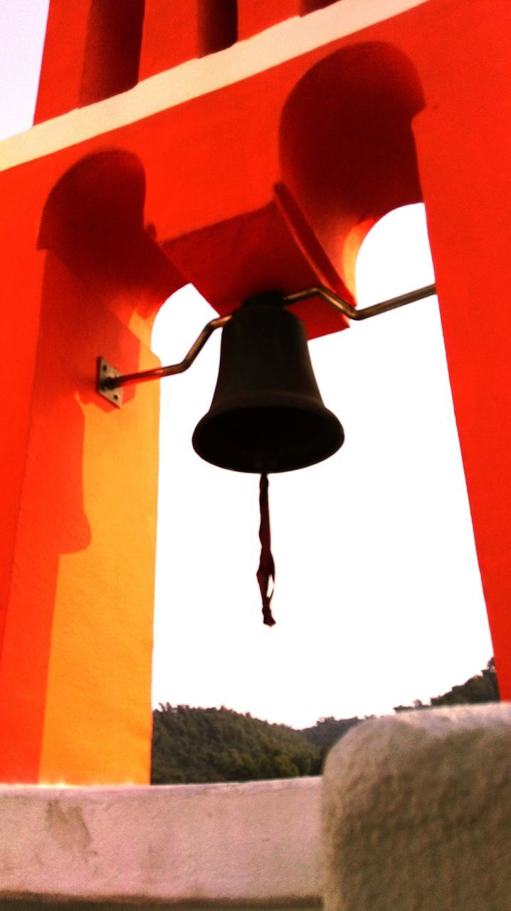 architecture, red, built structure, lighting equipment, low angle view, hanging, lantern, building exterior, wall - building feature, street light, indoors, clear sky, arch, sunlight, day, illuminated, no people, shadow, electric lamp