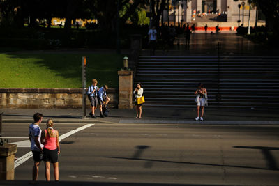 People walking on road in city