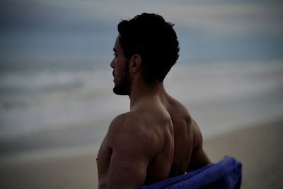 Portrait of shirtless man standing at home