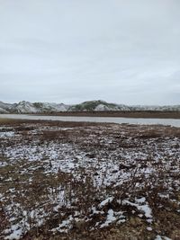 Scenic view of lake against sky during winter