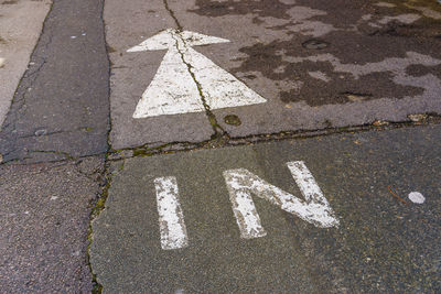 High angle view of arrow sign on road