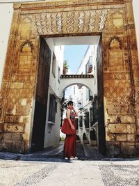 Woman standing at entrance of building