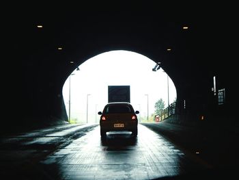 Cars on illuminated tunnel at night