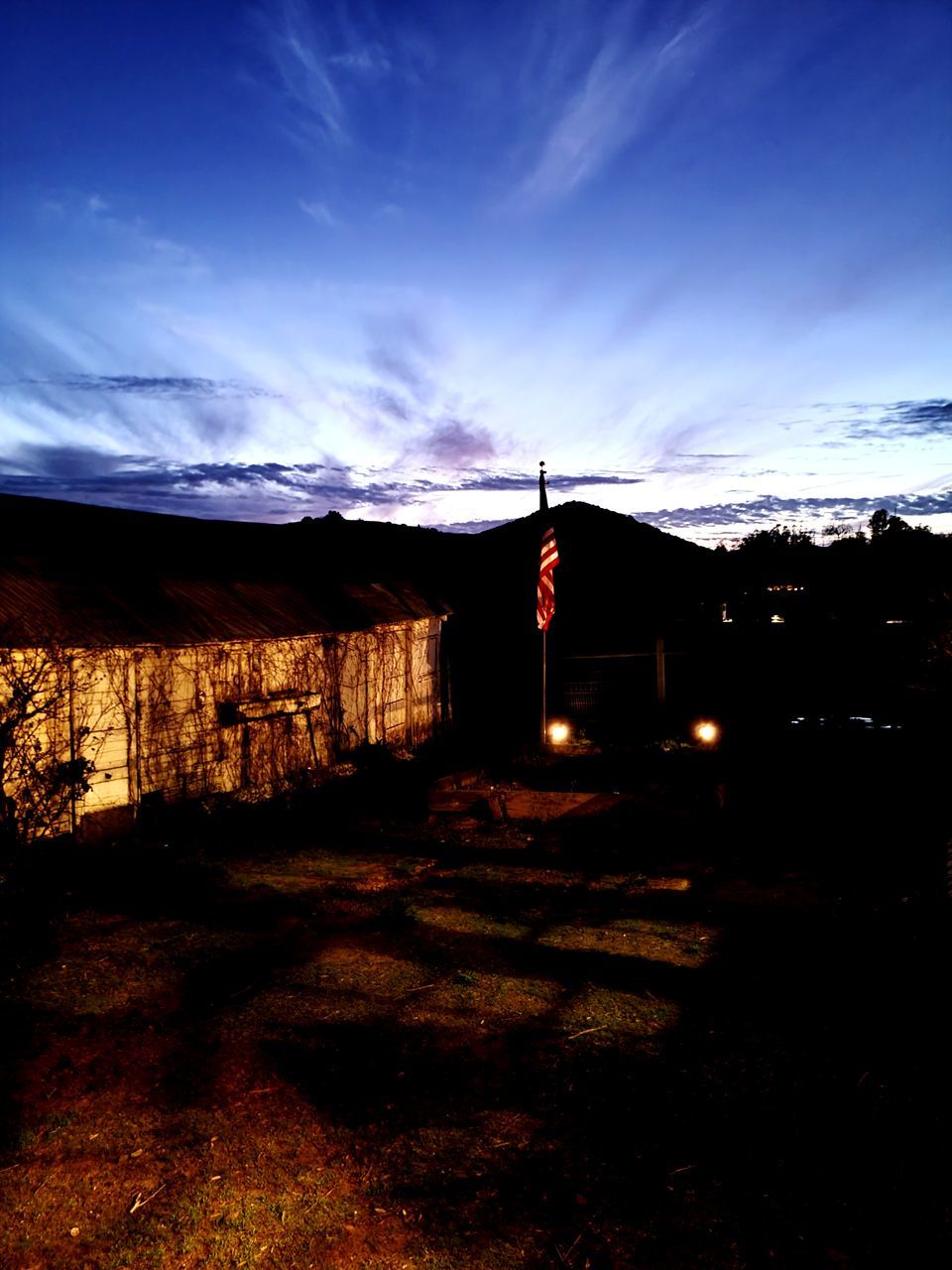 SILHOUETTE HOUSES ON FIELD AGAINST SKY