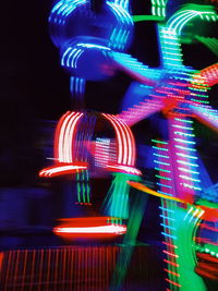 Illuminated ferris wheel at night