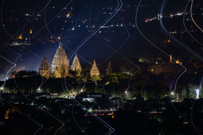 Aerial view of illuminated buildings in city at night