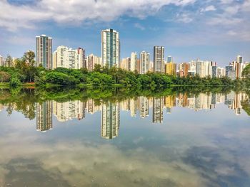 Reflection of buildings in lake against sky