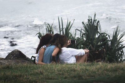 Rear view of a girl sitting on grass