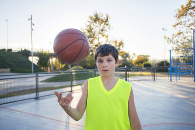 Boy playing basketball on court