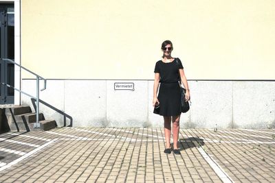 Full length of woman standing by railing