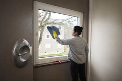 Woman cleaning window