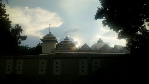 Low angle view of silhouette building against sky