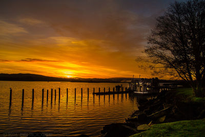 Scenic view of lake against sky during sunset