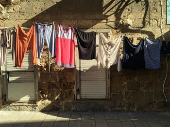 Close-up of clothes hanging on street