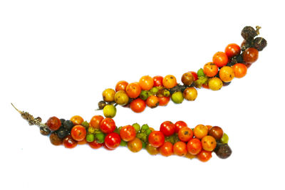 Close-up of berries over white background