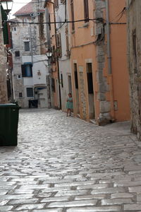 Empty alley amidst buildings in city