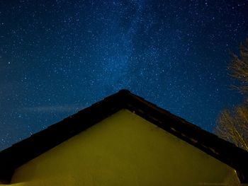 Low angle view of building against star field