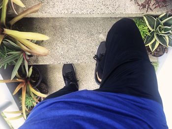 Low section of man wearing shoes